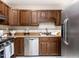 Functional kitchen with wood cabinets, stainless steel appliances, and ample counter space at 7704 Cresthill Ct, Raleigh, NC 27615