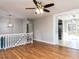 Open concept living room with hardwood floors and a view into the kitchen and rear of home at 7704 Cresthill Ct, Raleigh, NC 27615