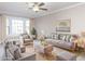 Bright living room with a bay window, offering comfortable seating and soft, neutral décor at 7704 Cresthill Ct, Raleigh, NC 27615