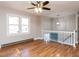 Bright, airy living room with hardwood floors, ceiling fan, and large windows at 7704 Cresthill Ct, Raleigh, NC 27615