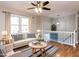 Cozy living room with hardwood floors, ceiling fan, and elegant decor at 7704 Cresthill Ct, Raleigh, NC 27615
