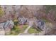 Stunning aerial view of a beautiful two-story home with mature trees and an expansive lawn at 8015 Papaya Dr, Raleigh, NC 27613