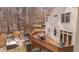 Beautiful wood deck, grilling area, patio with fire pit and hot tub in backyard surrounded by trees at 8015 Papaya Dr, Raleigh, NC 27613