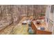 Large wood deck, grill, patio with fire pit and hot tub surrounded by mature trees in backyard at 8015 Papaya Dr, Raleigh, NC 27613