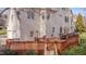 Backyard features a spacious deck with outdoor dining, stairs to yard, and grill at 8015 Papaya Dr, Raleigh, NC 27613