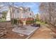 Backyard featuring a fire pit, stone patio, hot tub, bocce ball court and multilevel deck at 8015 Papaya Dr, Raleigh, NC 27613