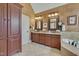 Bathroom with double vanity, granite countertops, soaking tub, and ample storage space at 8015 Papaya Dr, Raleigh, NC 27613
