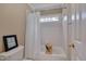 Bathroom featuring a tub with shower and white tile at 8015 Papaya Dr, Raleigh, NC 27613