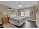Bedroom with a ceiling fan, an area rug, and a sunny window at 8015 Papaya Dr, Raleigh, NC 27613