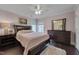 Bedroom with dark wood floors, pink walls, and furniture at 8015 Papaya Dr, Raleigh, NC 27613