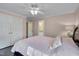 Bedroom with dark wood floors, pink walls, ensuite bathroom and walk-in closet at 8015 Papaya Dr, Raleigh, NC 27613