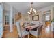 Charming dining room with hardwood floors, elegant light fixture, and a cozy atmosphere at 8015 Papaya Dr, Raleigh, NC 27613