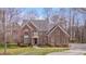 Charming brick home features lush landscaping, a well-maintained lawn, and a welcoming entrance at 8015 Papaya Dr, Raleigh, NC 27613