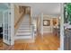 Elegant foyer with hardwood floors, a staircase, and classic architectural details at 8015 Papaya Dr, Raleigh, NC 27613