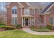 Inviting front entry features a brick facade, a covered porch, and charming curb appeal at 8015 Papaya Dr, Raleigh, NC 27613