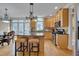 Open kitchen features wooden cabinets, stainless steel appliances, granite countertops, and an island with seating at 8015 Papaya Dr, Raleigh, NC 27613