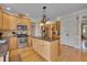 Spacious kitchen with wooden cabinets, stainless steel appliances, and an island with granite countertops at 8015 Papaya Dr, Raleigh, NC 27613