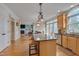 Spacious kitchen with a granite island and wooden cabinets that flows into the adjacent living space at 8015 Papaya Dr, Raleigh, NC 27613