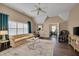 Spacious living room with hardwood floors, tall ceilings, and many windows at 8015 Papaya Dr, Raleigh, NC 27613