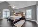 Spacious main bedroom with vaulted ceiling, ceiling fan, hardwood floors, and natural light at 8015 Papaya Dr, Raleigh, NC 27613