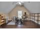 Office space with hardwood floors, a desk, and shelving at 8015 Papaya Dr, Raleigh, NC 27613