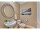 Cozy powder room features pedestal sink, round mirror, and stylish decor at 8015 Papaya Dr, Raleigh, NC 27613