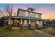 Charming two-story home featuring a spacious covered porch with brick supports and white trim at 802 N Elizabeth St, Durham, NC 27701