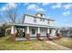 Inviting two-story home with a wide covered porch, showcasing classic architectural details and curb appeal at 802 N Elizabeth St, Durham, NC 27701