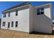 The back exterior features white siding, multiple windows and a door leading to the backyard at 81 Reece Dr, Sanford, NC 27332
