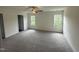 Large bedroom with plush carpeting, ceiling fan, and well-lit by natural light from the dual windows at 81 Reece Dr, Sanford, NC 27332