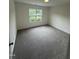 Bedroom with window view of a landscaped front yard at 81 Reece Dr, Sanford, NC 27332