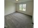 Carpeted bedroom with a bright window view at 81 Reece Dr, Sanford, NC 27332