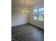 Bright dining area with hardwood floors, a modern chandelier, and a large window at 81 Reece Dr, Sanford, NC 27332