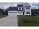 Charming two-story home featuring a two-car garage, dark shutters, and a well-manicured lawn at 81 Reece Dr, Sanford, NC 27332