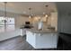 Open kitchen with breakfast bar, granite counters, stainless appliances, and stylish pendant lights at 81 Reece Dr, Sanford, NC 27332