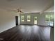 Spacious living room with hardwood floors, a ceiling fan, and plenty of natural light from multiple windows at 81 Reece Dr, Sanford, NC 27332