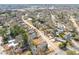 An aerial perspective showcasing a residential community with tree-lined streets and a mix of home styles at 838 Woodburn Rd, Raleigh, NC 27605