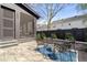Backyard patio with a fire pit and seating surrounded by landscaping and privacy fencing at 838 Woodburn Rd, Raleigh, NC 27605