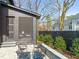 Backyard patio with a fire pit and seating surrounded by landscaping and privacy fencing at 838 Woodburn Rd, Raleigh, NC 27605