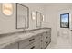 Modern bathroom with double vanity, stylish mirrors, and a view to an attached bathroom at 838 Woodburn Rd, Raleigh, NC 27605
