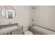 Elegant bathroom featuring a stylish vanity, sink, toilet, and a tiled shower-tub combo at 838 Woodburn Rd, Raleigh, NC 27605