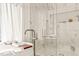 A freestanding tub next to a glass shower with marble tile walls and upscale fixtures at 838 Woodburn Rd, Raleigh, NC 27605