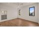 Inviting bedroom showcases hardwood floors, a modern ceiling fan, and windows that provide ample natural light at 838 Woodburn Rd, Raleigh, NC 27605