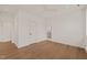 Generously sized bedroom with hardwood floors, recessed lighting, and a view to an attached bathroom at 838 Woodburn Rd, Raleigh, NC 27605