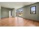 Spacious bedroom boasts hardwood floors, ambient recessed lighting, and large windows for natural light at 838 Woodburn Rd, Raleigh, NC 27605