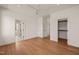 Spacious bedroom with beautiful hardwood floors, a ceiling fan, and ample closet space at 838 Woodburn Rd, Raleigh, NC 27605