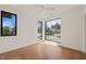 Bright bedroom with hardwood floors, a ceiling fan, and black frame windows framing a scenic view at 838 Woodburn Rd, Raleigh, NC 27605