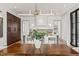 A dining room with a wood table and an artistic light fixture at 838 Woodburn Rd, Raleigh, NC 27605