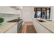 Modern kitchen with stainless steel appliances, stone countertops, and light wood floors at 838 Woodburn Rd, Raleigh, NC 27605