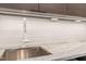 Modern kitchen featuring a stainless steel sink, stylish white faucet, and sleek countertops at 838 Woodburn Rd, Raleigh, NC 27605